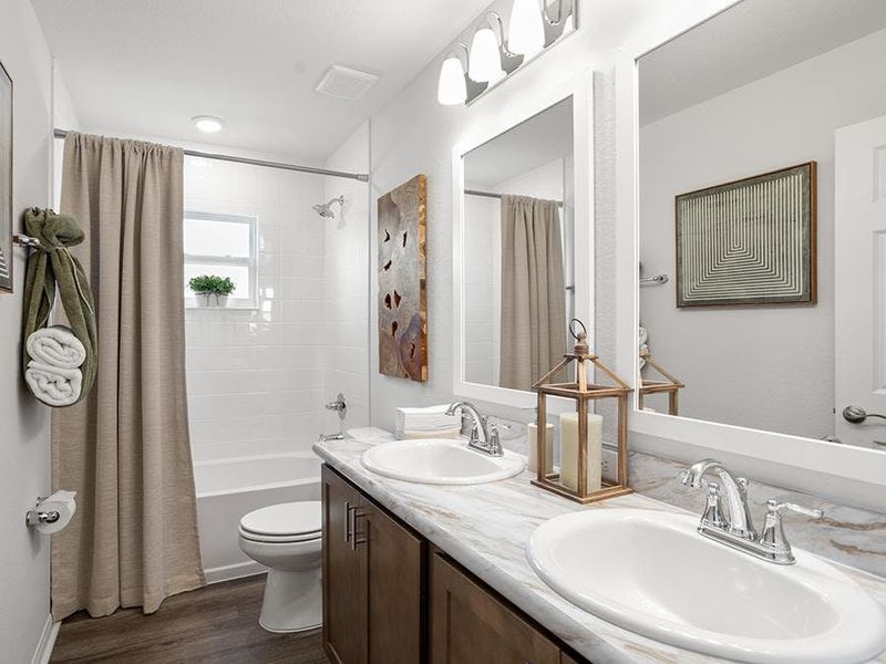 You will appreciate thoughtful features such as this dual-vanity hall bath - Serendipity model home in Lakeland, FL You will appreciate thoughtful features such as this dual-vanity hall bath - Serendipity model home in Lakeland, FL