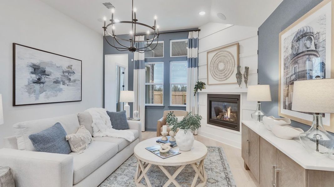 Revel in this Spring Creek living room's chic chandelier, inviting fireplace, and exquisite decor.
