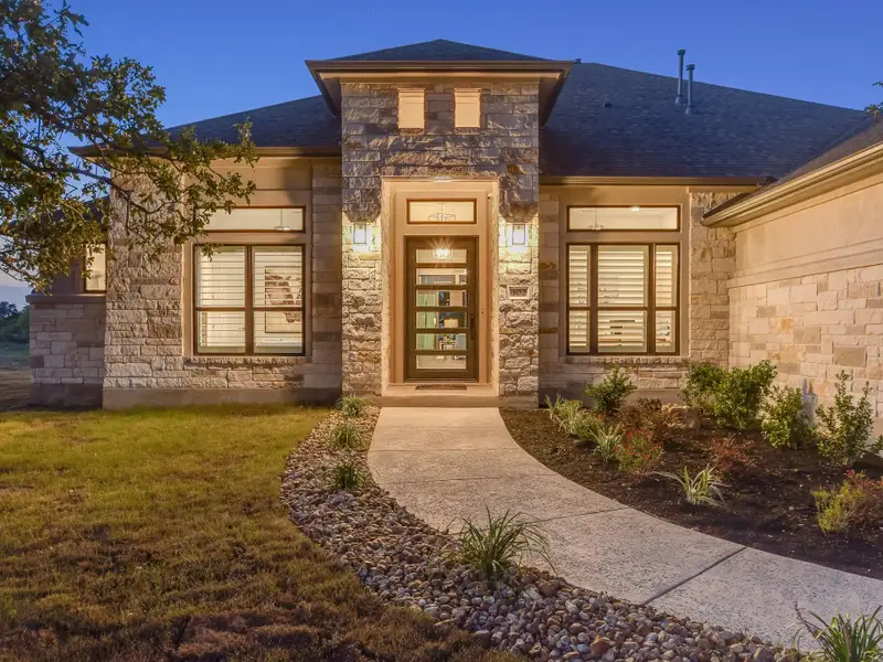 Front exterior of a home in the Whispering Wind community, located in Bertram, TX (Image 10).