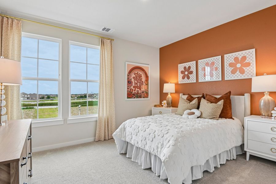 A bedroom with a large window.