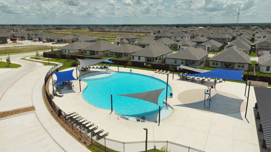 Elegant pool with stylish shade sails in Southern Pointe, College Station, offering luxury leisure.