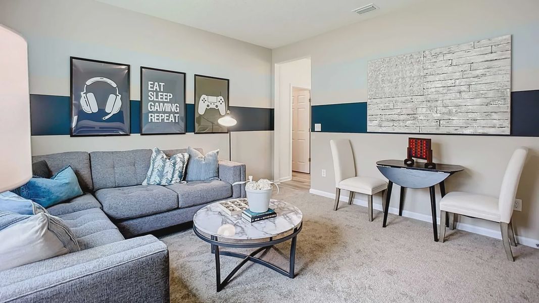 Elegant grey sectional and artful touches create a modern, upscale haven in Panther Creek.