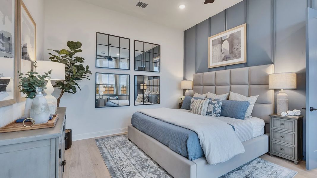 Experience luxury with a tufted headboard, mirrored accents, and rich paneling in Spring Creek.