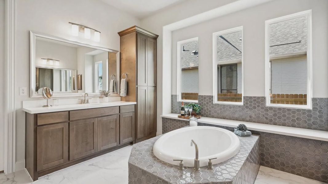 Experience elegance with hexagonal tile design, oval bathtub, and premium wooden cabinetry in Ridge Crossing. Experience elegance with hexagonal tile design, oval bathtub, and premium wooden cabinetry in Ridge Crossing.