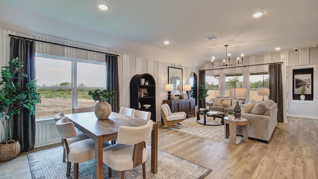 Distinctive chandelier and hardwood floors enrich this Prairie Green home's luxurious open-plan ambiance.