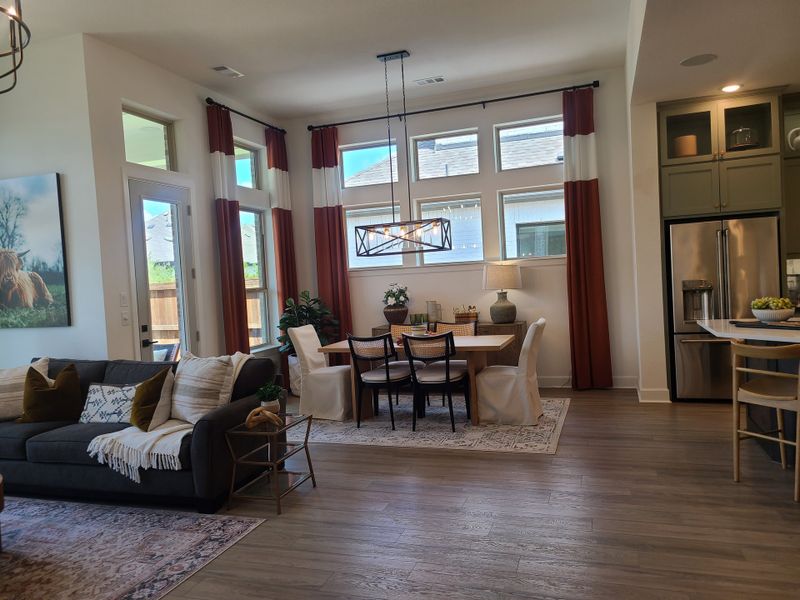 An inviting open-plan living area with elegant dining space, large windows, and modern decor. An inviting open-plan living area with elegant dining space, large windows, and modern decor.