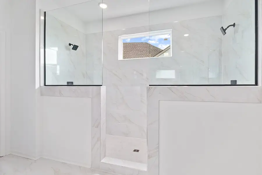 A bathroom with a glass shower. A bathroom with a glass shower.