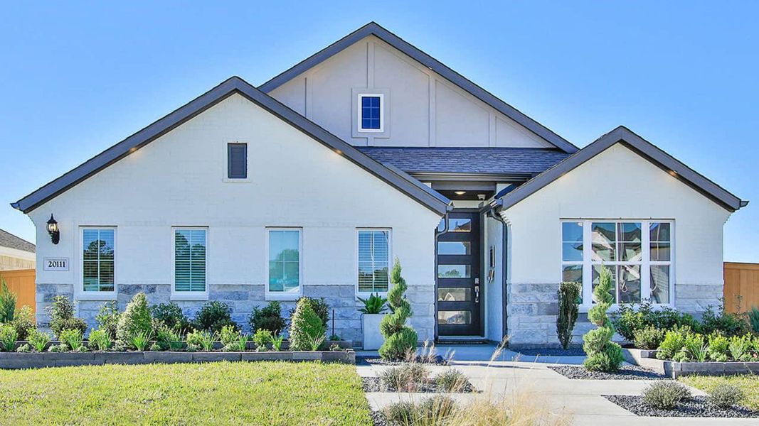 Elegant Cypress Green home features sleek stone accents and expansive windows, offering a refined living experience. Elegant Cypress Green home features sleek stone accents and expansive windows, offering a refined living experience.