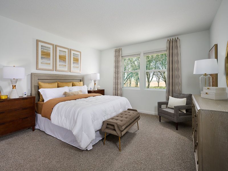 The primary bedroom of the Orchid at Lakes at Bella Lago
