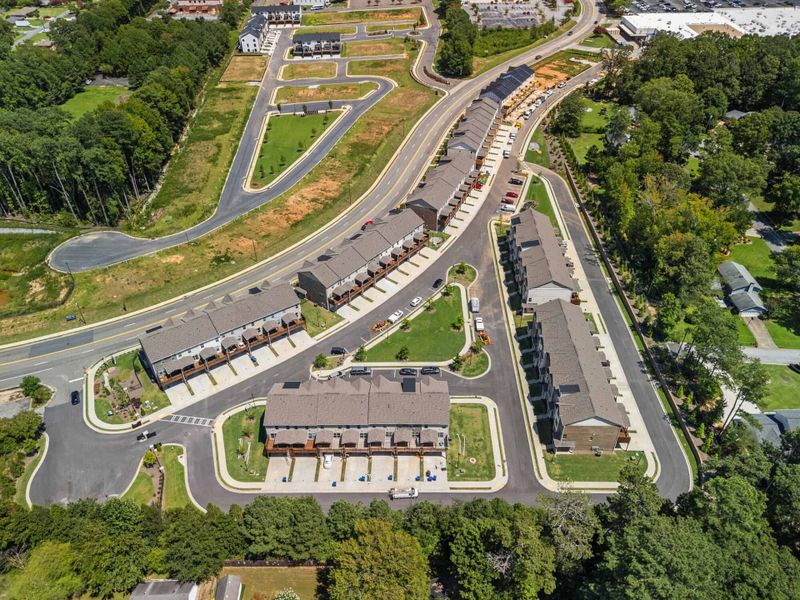 Aerial view of the Towns at Enclave community in Lawrenceville, GA, showing layout and nearby surroundings (Image 11). Aerial view of the Towns at Enclave community in Lawrenceville, GA, showing layout and nearby surroundings (Image 11).