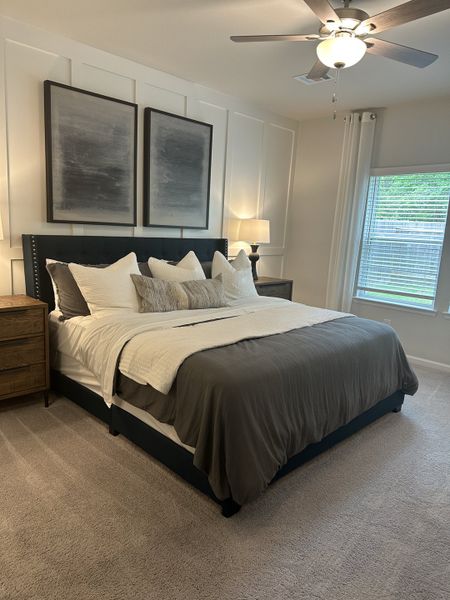 A cozy bedroom featuring a plush bed, elegant artwork, and soft lighting for a serene ambiance. A cozy bedroom featuring a plush bed, elegant artwork, and soft lighting for a serene ambiance.