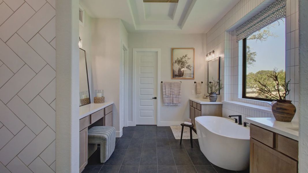 Experience sophistication with a freestanding tub and herringbone tile wall at Verandas at the Rim.