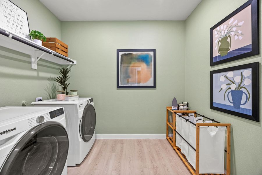 A room with a washing machine and a table. A room with a washing machine and a table.