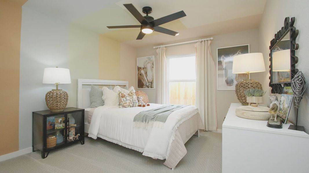 Elegant pale walls and woven lamps add luxury to this Colony at Pinehurst bedroom.