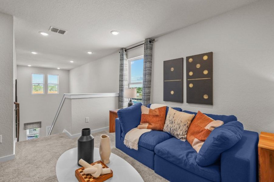 A living room with a blue couch.