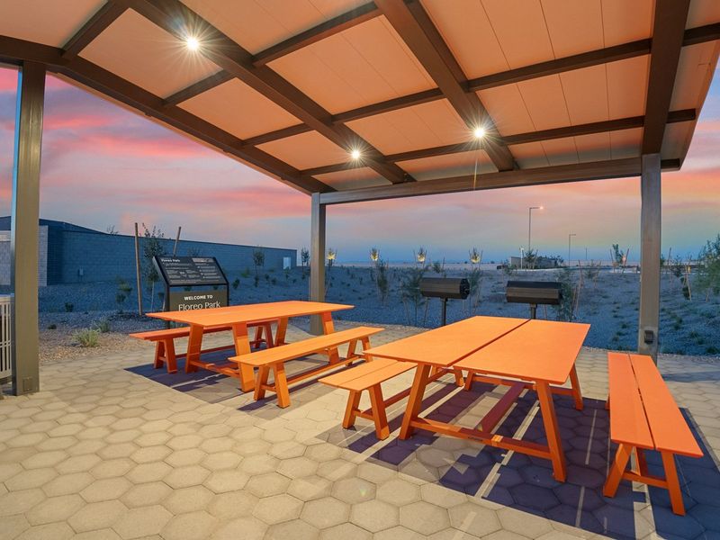 A group of tables and chairs on a patio by the water. A group of tables and chairs on a patio by the water.