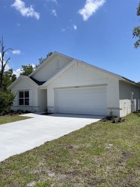 A modern white home with a clean driveway and green lawn in Citrus County Spot Lots by D.R. Horton (Citrus Springs, FL). A modern white home with a clean driveway and green lawn in Citrus County Spot Lots by D.R. Horton (Citrus Springs, FL).
