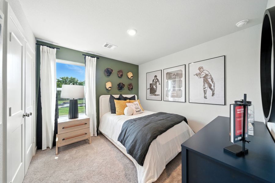 A bedroom with a bed and a desk. A bedroom with a bed and a desk.