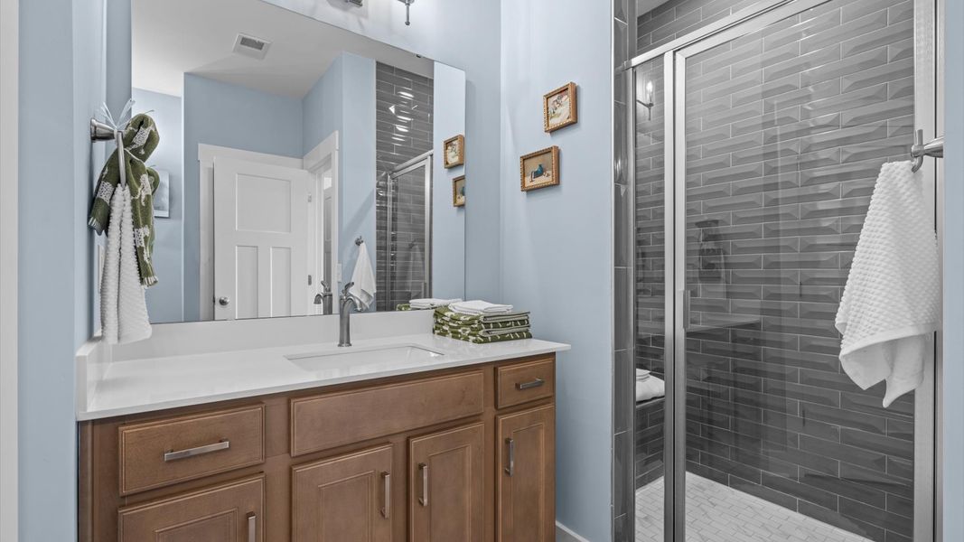 Spacious and modern primary bathroom with walk-in shower and first-class double vanity setup located in Greenville, SC