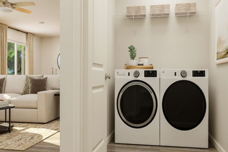 A room with a washing machine and a couch.