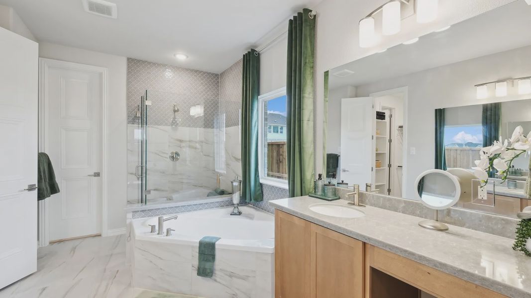 Indulge in marble elegance; dual vanity and soaking tub evoke refinement at Wildflower Ranch. Indulge in marble elegance; dual vanity and soaking tub evoke refinement at Wildflower Ranch.