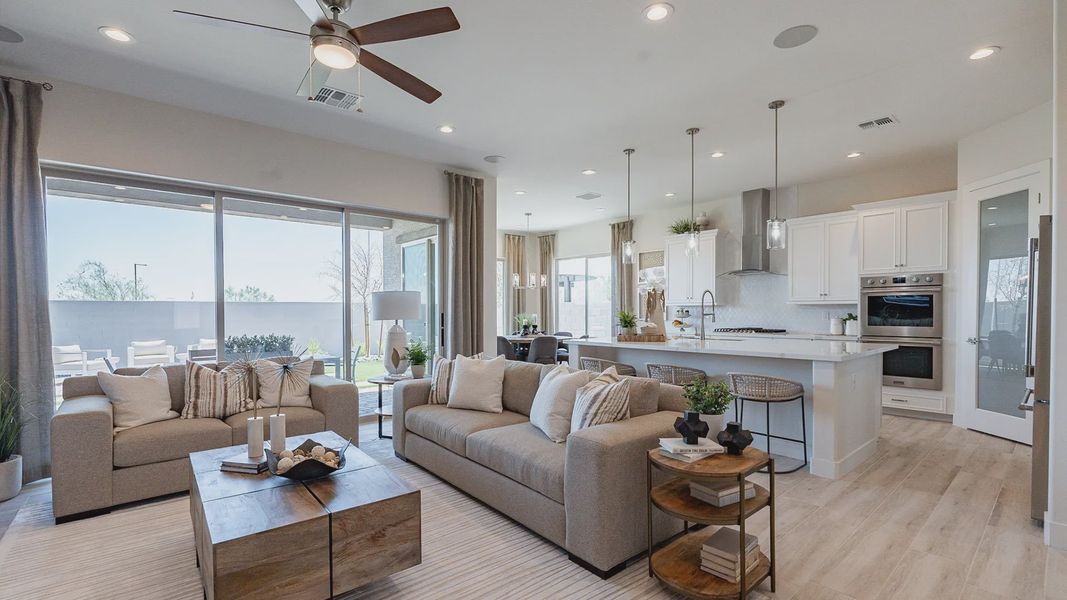 The Windrose home boasts open-concept design, sleek wood floors, and expansive windows for luxurious living.