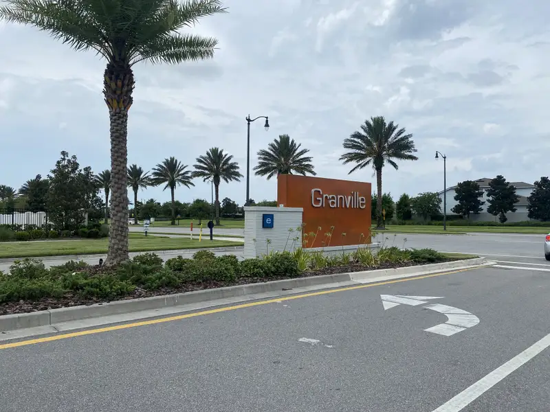 A welcoming entrance with palm trees and a community sign at Granville at eTown 38' by David Weekley Homes (Jacksonville, FL).