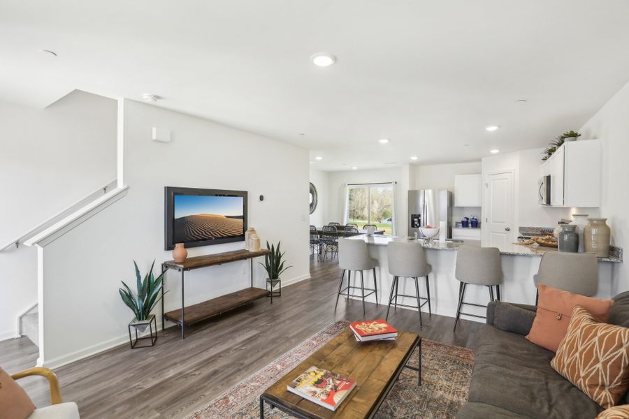 A living room with a tv and couches. A living room with a tv and couches.