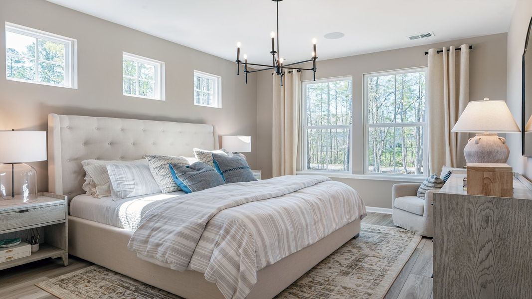 Primary suite with lots of space, large windows, and natural light