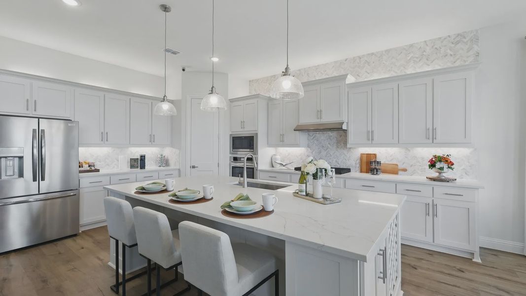 Luxurious marble island and herringbone backsplash define this Rio Vista kitchen's elegance. Luxurious marble island and herringbone backsplash define this Rio Vista kitchen's elegance.