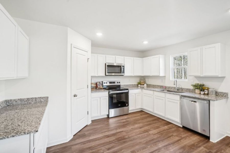 A kitchen with white cabinets. A kitchen with white cabinets.