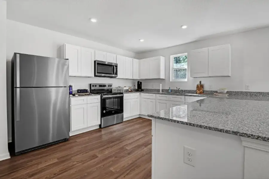 A kitchen with white cabinets. A kitchen with white cabinets.