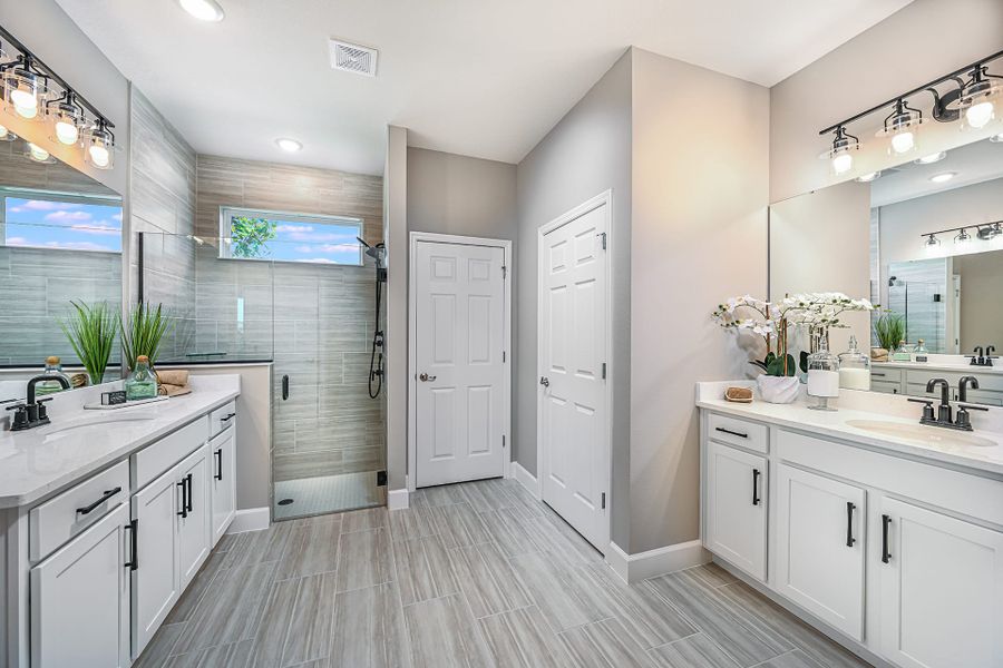 Our modern and spacious owner's suite bathroom is the perfect backdrop for self-care and spa days