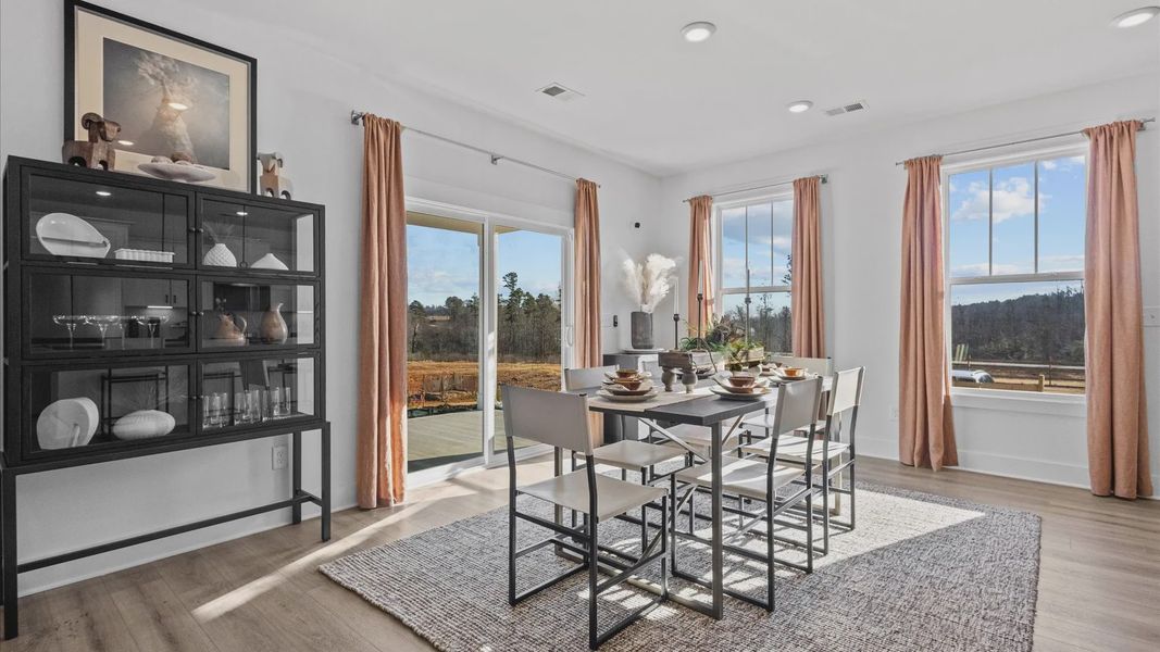 Modern breakfast area with black accents and large windows at Wells Crossing by DRB Homes in Seneca, SC