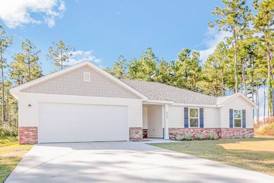 A house with garages and trees. A house with garages and trees.