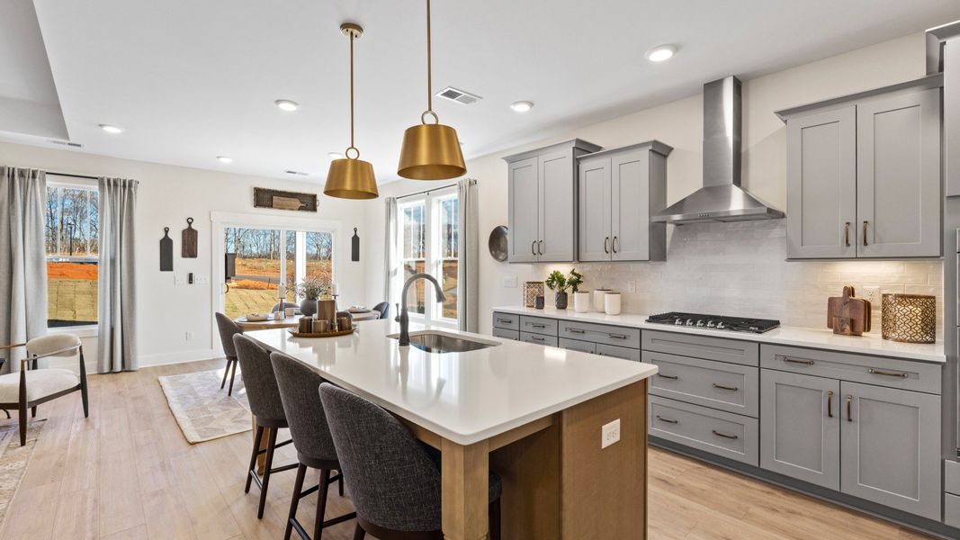 Elegant kitchen with large island and pendant lighting in this first-class DRB Homes design Elegant kitchen with large island and pendant lighting in this first-class DRB Homes design