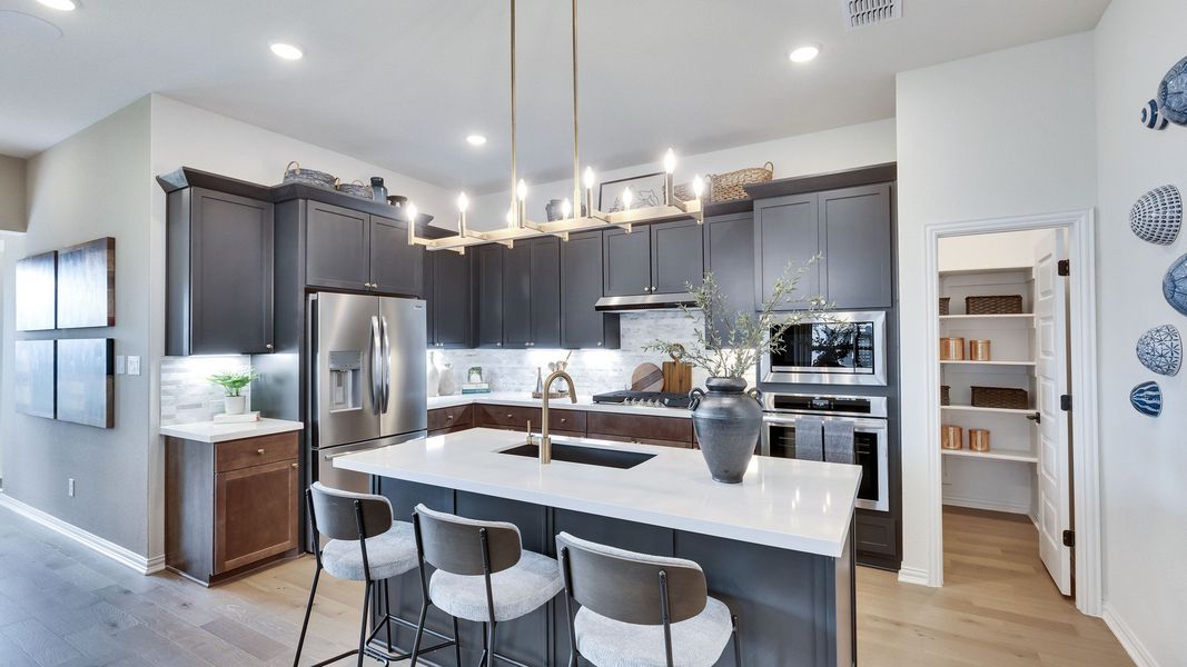 Experience sleek elegance with dark cabinetry, premium appliances, and designer finishes at Lakeside Meadows. Experience sleek elegance with dark cabinetry, premium appliances, and designer finishes at Lakeside Meadows.