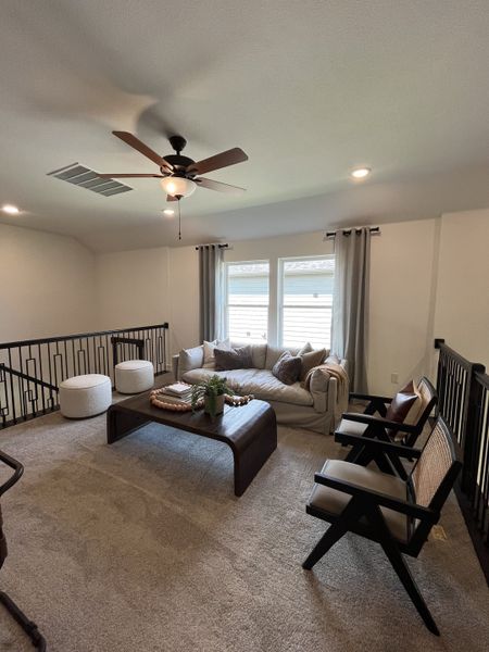 A cozy loft with plush seating, soft carpeting, a stylish coffee table, and natural light filtering through large windows. A cozy loft with plush seating, soft carpeting, a stylish coffee table, and natural light filtering through large windows.