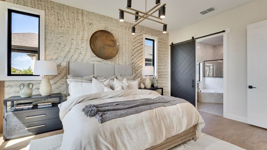 Experience refined elegance with textured walls and stylish barn door in Lakeside Meadows bedroom. Experience refined elegance with textured walls and stylish barn door in Lakeside Meadows bedroom.