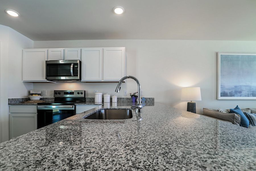 A kitchen with marble counters.