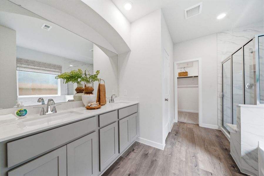 A bathroom with white cabinets.
