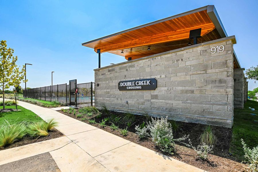 Entrance to the Double Creek Crossing – Craftsman Series community in Round Rock, TX, featuring signage and landscaping (Image 12).
