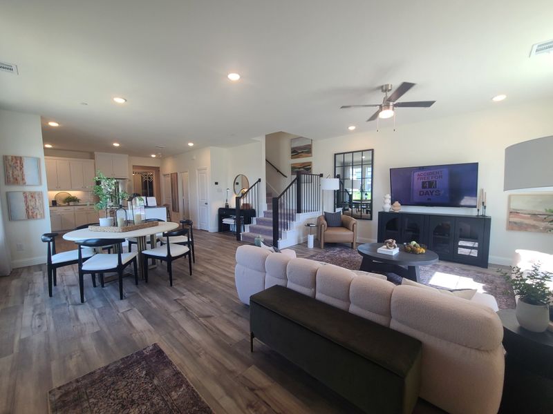 A contemporary open living area with hardwood floors, sleek furniture, and abundant natural light.