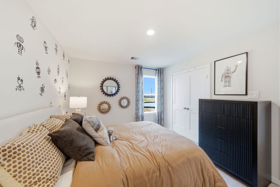 A bedroom with a bed and a fireplace. A bedroom with a bed and a fireplace.