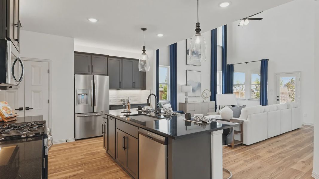 Sleek black kitchen island and soaring double-height ceiling embody sophistication in Westridge.