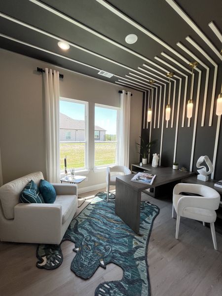 A modern office with unique ceiling design, sleek furniture, and artistic rug, illuminated by natural light and elegant pendants. A modern office with unique ceiling design, sleek furniture, and artistic rug, illuminated by natural light and elegant pendants.