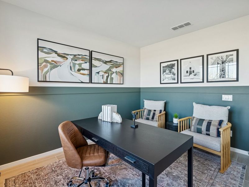 A living room with a table and chairs. A living room with a table and chairs.