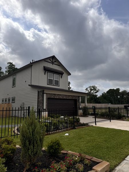 A modern gray home with a black fence and manicured lawn in Aldine Pines by Saratoga Homes (Houston, TX). A modern gray home with a black fence and manicured lawn in Aldine Pines by Saratoga Homes (Houston, TX).