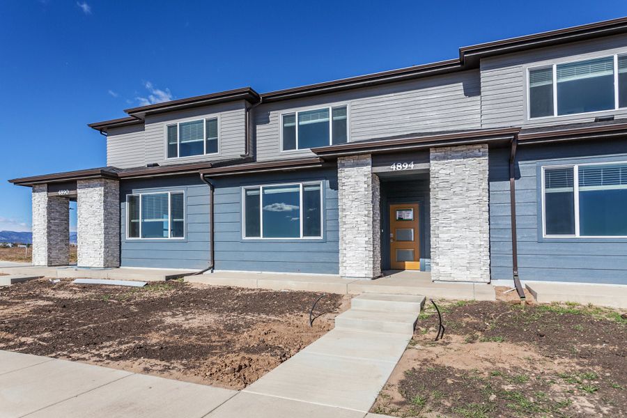 Front exterior of a home in the Timnath Ranch Townhomes community, located in Timnath, CO (Image 4).