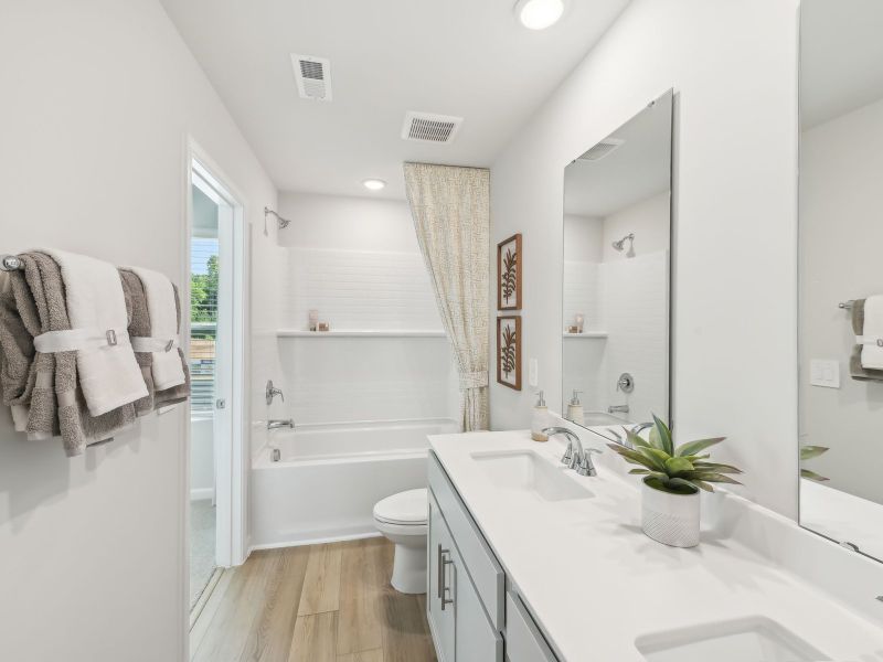 Two secondary bedrooms share a connected bathroom with dual sinks. Two secondary bedrooms share a connected bathroom with dual sinks.